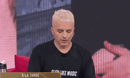 a man wearing a black shirt that says flow like music on it