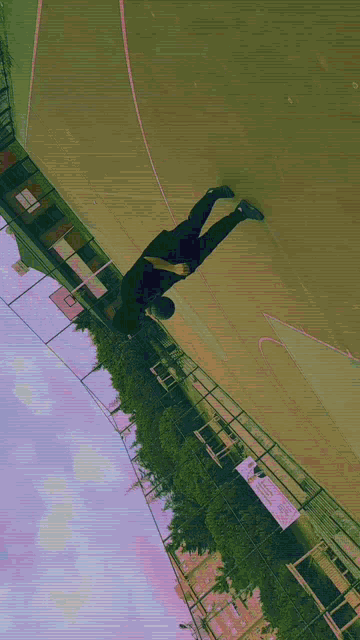 a person is doing a handstand on a basketball court with a sign that says ' basketball court ' on it