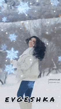 a woman is standing in the snow holding a snowflake and the name evgesha is on the bottom