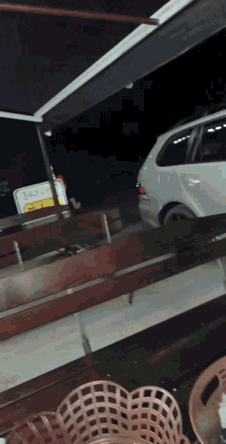a car is parked in front of a sign that says bakery on it