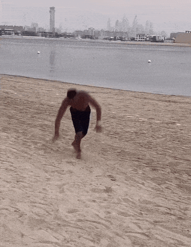 a shirtless man standing on a beach with the words mounir moons written below him