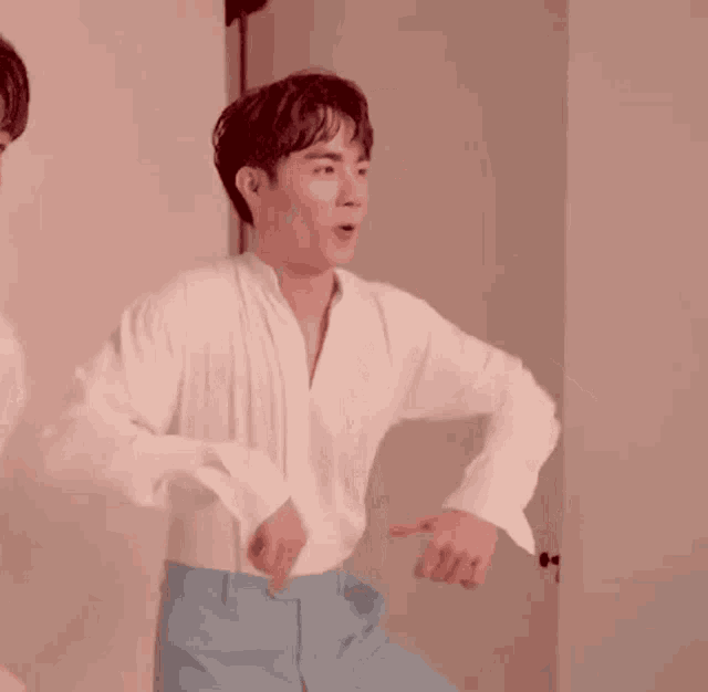 a man in a white shirt and blue pants is dancing .