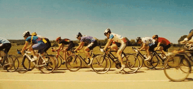 a group of cyclists are racing down a road
