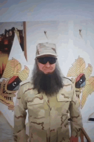 a man with a long beard is wearing sunglasses and a military uniform