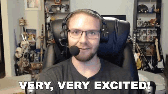 a man wearing headphones and glasses says very very excited