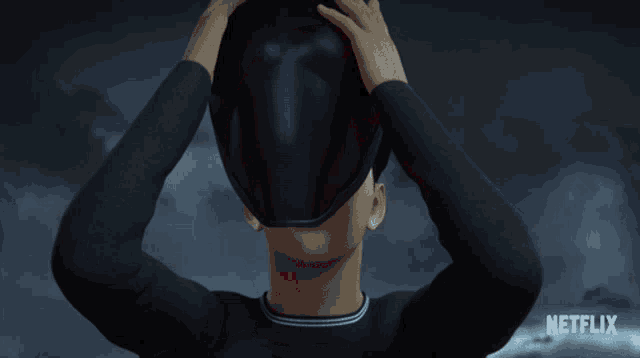 a person wearing a helmet that says netflix on the bottom left