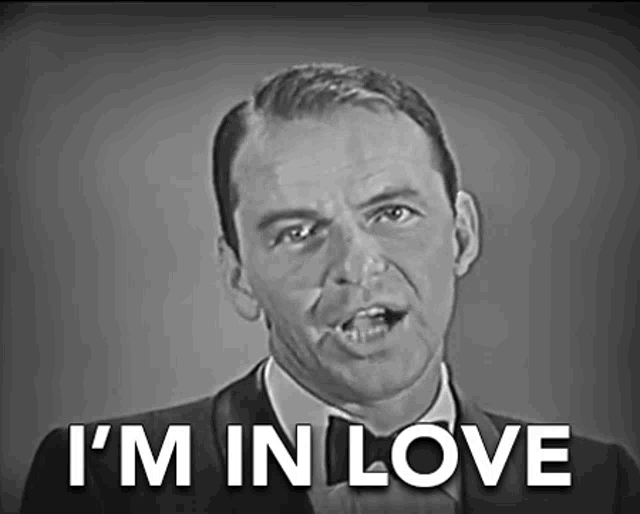 a man in a suit and tie says " i 'm in love "