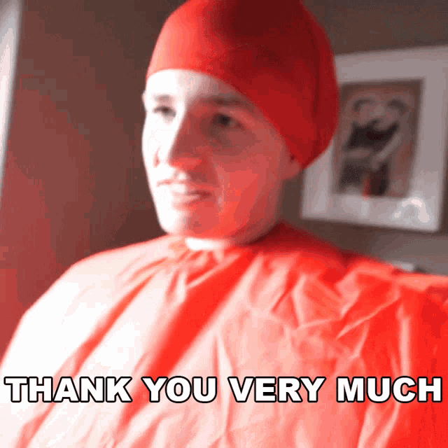 a man wearing a red cape and a red hat says " thank you very much "