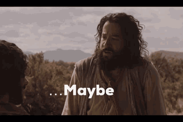 a man with a beard is talking to another man and the words maybe are visible