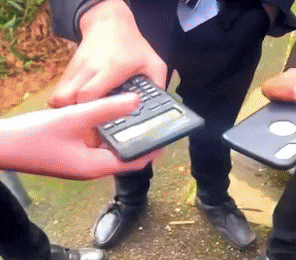 a man in a suit is holding a calculator in his hands