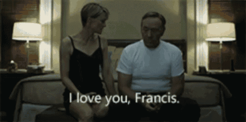 a man and a woman are sitting on a bed and the woman is saying i love you francis