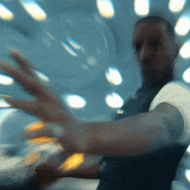 a blurry picture of a man 's face with his hands outstretched
