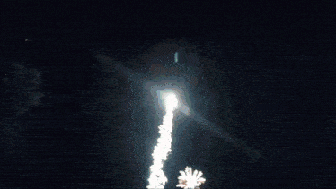 a fireworks display in the night sky with the sun shining through