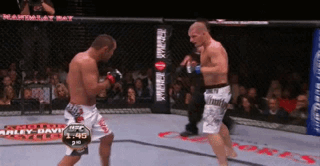 two men are fighting in a boxing ring with a ufc logo in the corner