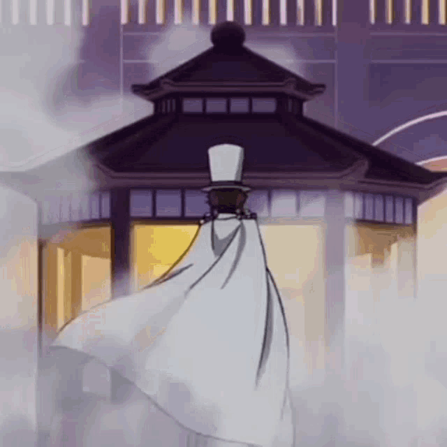 a man in a top hat and cape is standing in front of a gazebo in a foggy area .
