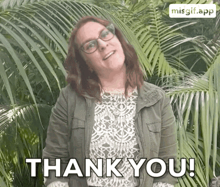 a woman wearing glasses is standing in front of palm trees and says thank you