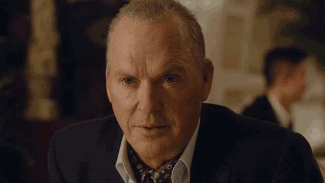 a close up of a man 's face with a serious look on his face