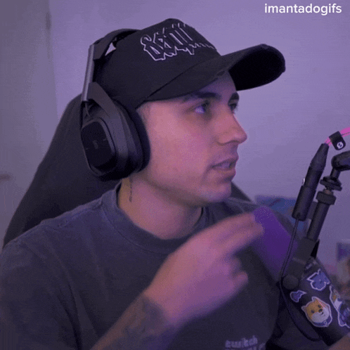a man wearing headphones and a hat that says ' sonic ' on it