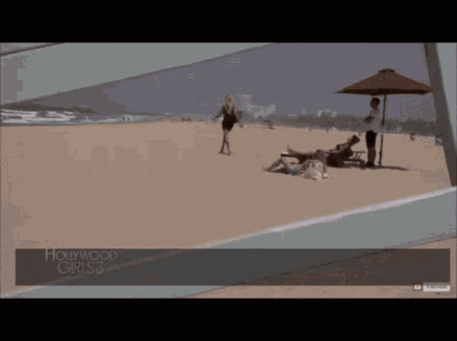 a woman walking on a beach with hollywood girls 3 written on the bottom