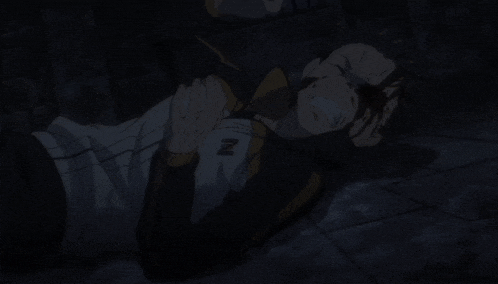 a man is laying on the ground with the letter z on his jacket