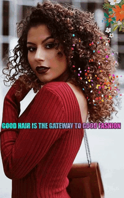 a woman with curly hair is wearing a red sweater with the words good hair is the gateway to good fashion below her