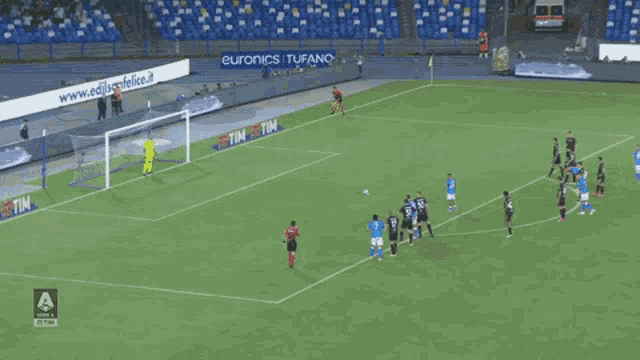 a group of soccer players on a field with an ad for euronics i tufano behind them