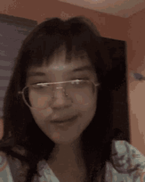 a close up of a person 's face with glasses .