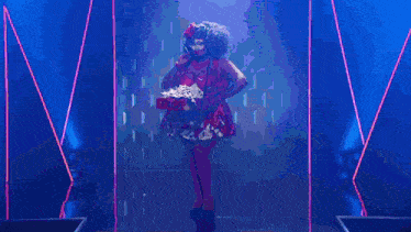 a stage with a red curtain and smoke coming out of the door