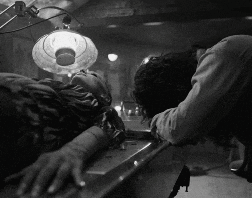 a person laying on a table with a light on