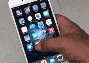 a person is holding a smart phone with a lot of apps on it