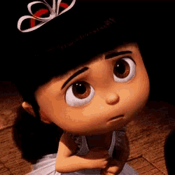 a close up of a cartoon character with a bow on her head .