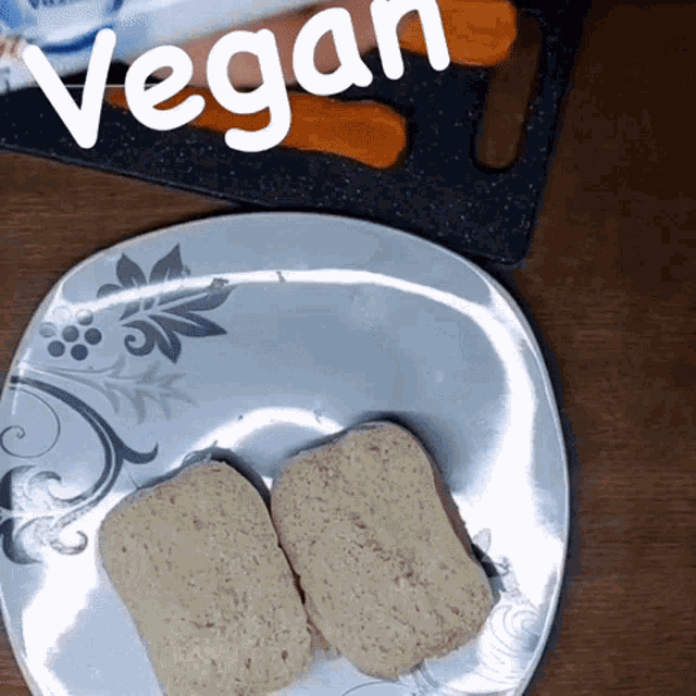 a plate with two slices of bread on it with the word vegan written above it