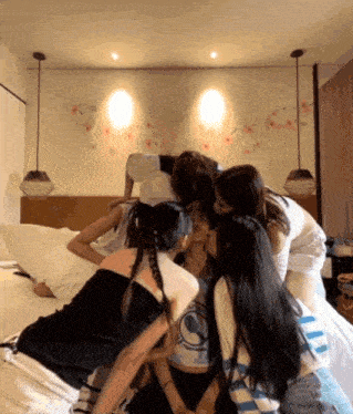 a group of girls are huddled around a woman wearing a shirt that says ' i love you '