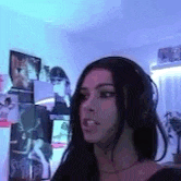 a woman wearing headphones is sitting in a room .