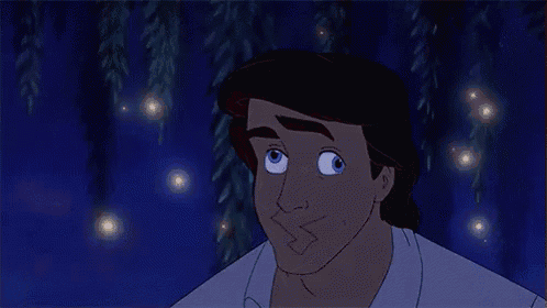 a close up of a cartoon character 's face with fireflies flying around him .