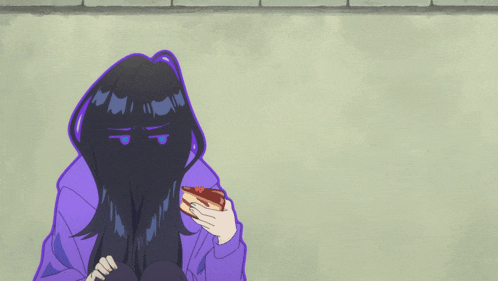 a girl in a purple hoodie is holding a piece of cake in front of her face