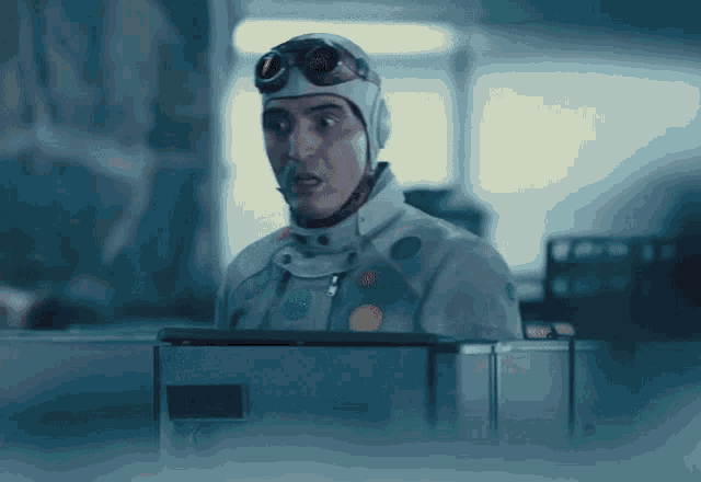 a man wearing a helmet and goggles looks at something