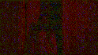 a woman in a white shirt is standing in a hallway