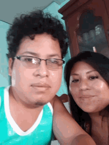 a man and a woman are posing for a picture