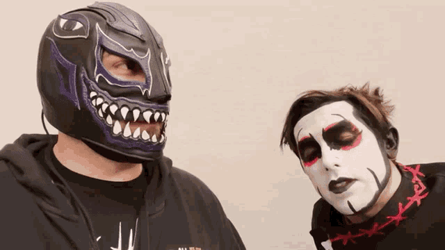 a man wearing a purple mask and a man wearing white face paint