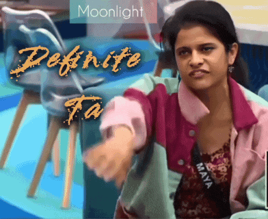 a woman is sitting in front of a sign that says moonlight and define ta