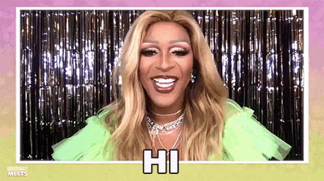 a woman in a green dress is smiling and says hi