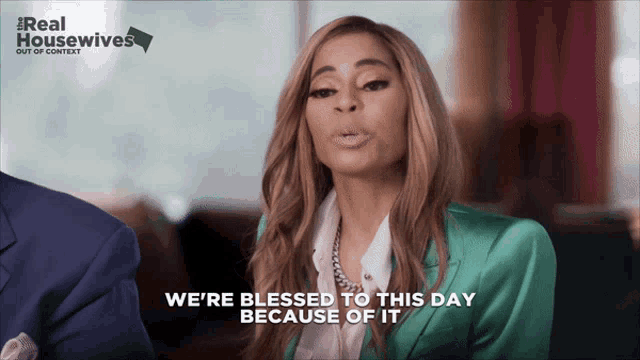 a woman in a green suit says we 're blessed to this day because of it