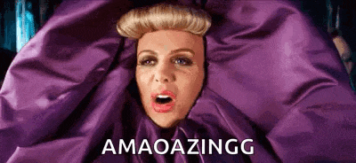 a woman is wrapped in a purple blanket with the words `` amaoazingg '' written below her .