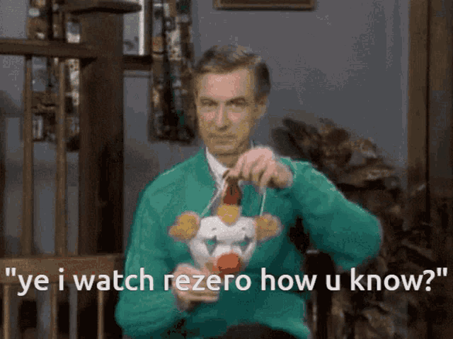a man wearing a green sweater and tie is holding a clown toy and says ye i watch rezero how u know