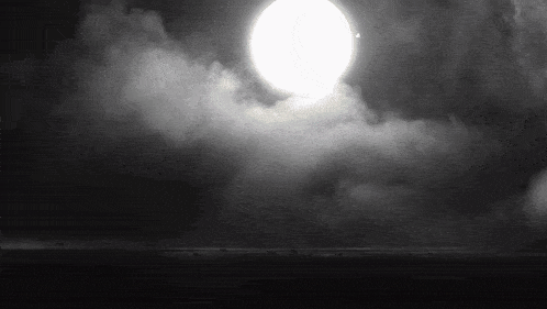 the sun is shining through the clouds in the dark sky