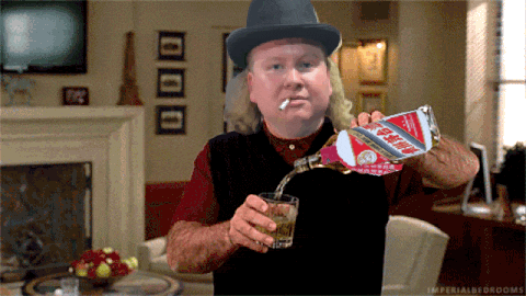 a man in a top hat is pouring a drink from a can that says coca cola