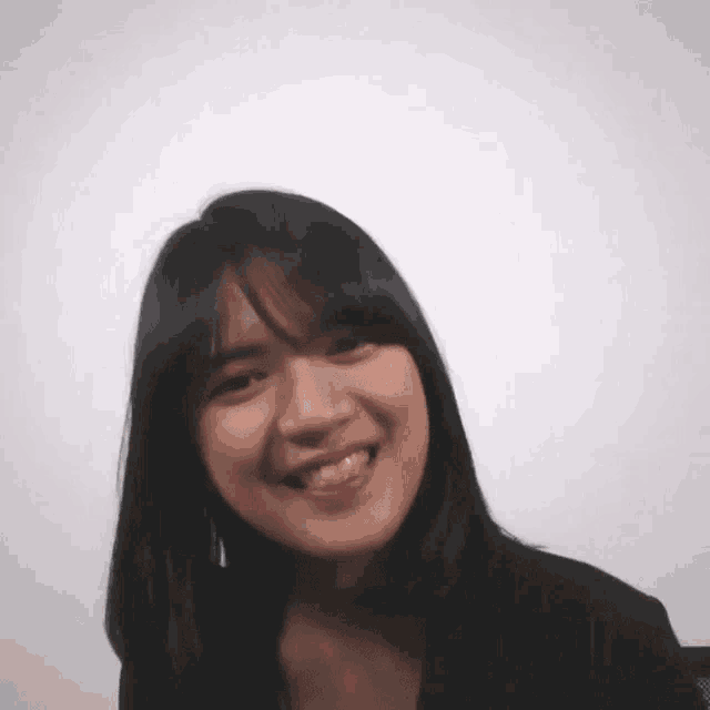 a close up of a woman 's face with a smile on her face