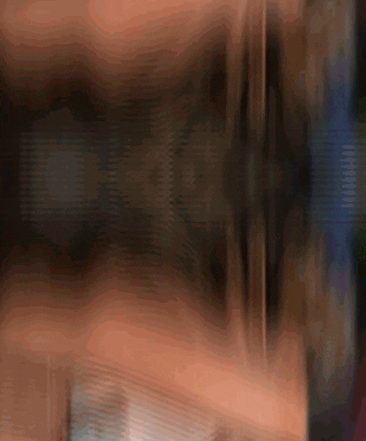 a blurry picture of a person 's face and a yellow object