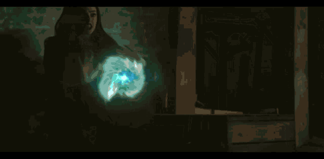 a woman is surrounded by a glowing green sphere